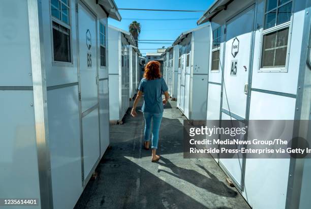 Riverside Pallet Shelter resident Deana Ingram walks to her shelter which is home for now as she works to get through the hard times of being...