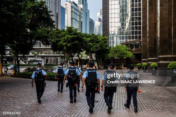 Police patrol in the Wan Chai district of Hong Kong on October 1 near the venue of an official flag raising ceremony to celebrate China's National...