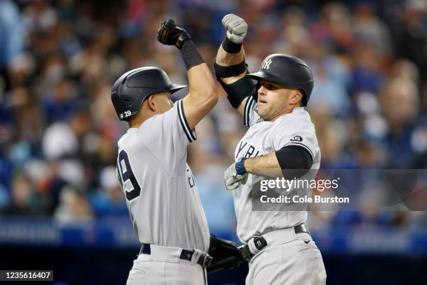 Gio Urshela and Brett Gardner of the New York Yankees celebrate Gardners solo home run in the ninth inning of their MLB game against the Toronto Blue...