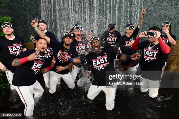 The Atlanta Braves celebrate in the center field waterfall after winning the NL Eastern Division against the Philadelphia Phillies at Truist Park on...