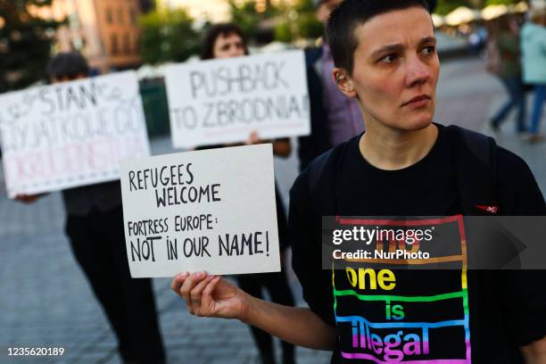 People hold banners during a protest in solidarity with Afghan and other refugees stuck at Polish-Belarusian border. Krakow, Poland on September 3,...