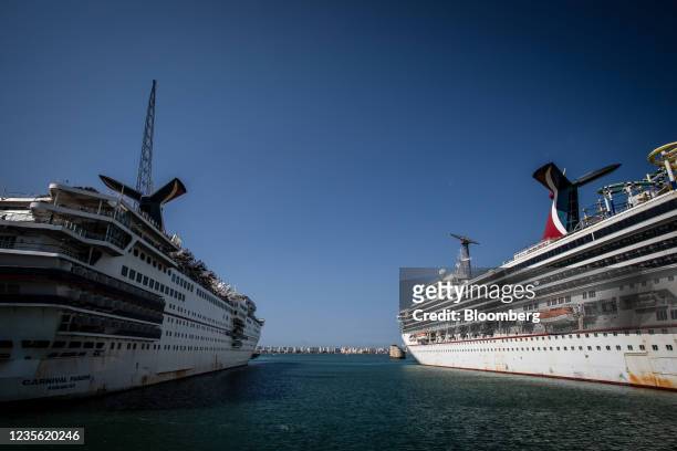 The Carnival Paradise cruise ship, operated by Carnival Corp., left, and the Carnival Sunshine cruise ship, operated by Carnival Corp., right, during...