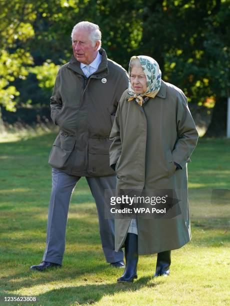 Queen Elizabeth II and Prince Charles, Prince of Wales walk to the Balmoral Estate Cricket Pavilion to mark the start of the official planting season...
