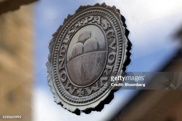 Logo on a window of a Banca Monte dei Paschi di Siena SpA bank branch in Siena, Italy, on Monday, Sept. 20, 2021. After more than 500 years as a...