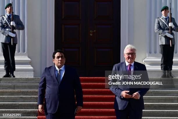 German President Frank-Walter Steinmeier welcomes Libya's President Mohammad Younes Menfi with honour guard during their meeting at the Bellevue...