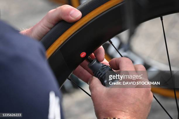 Illustration picture shows a technician checking the pressure of a tyre during a training and track reconaissance session ahead of the 118th edition...