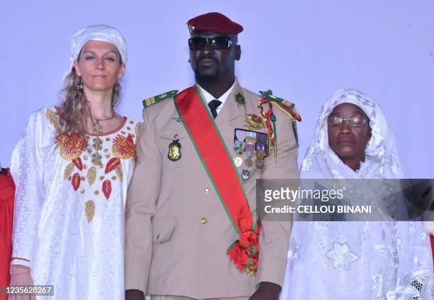 Guinea junta leader Colonel Mamady Doumbouya, poses with his wife and his mother at his swearing in ceremony as president of country transion on...