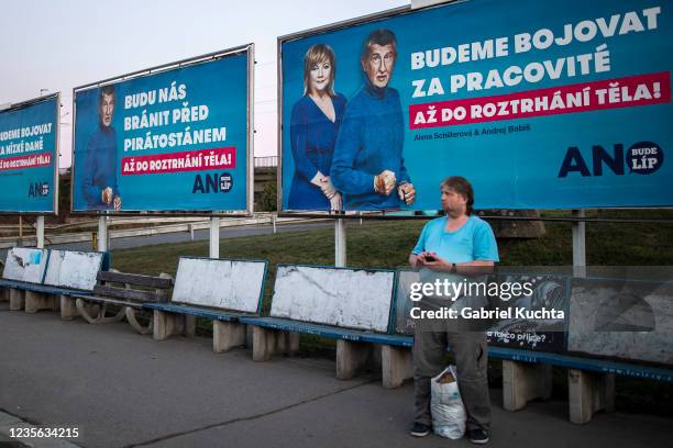 Man stands by an election campaign poster for the Czech Prime Minister Andrej Babis of the ANO party placed at the street on October 01, 2021 in...