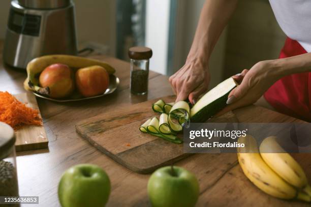 woman preparing dinner - cutting green apple stock pictures, royalty-free photos & images