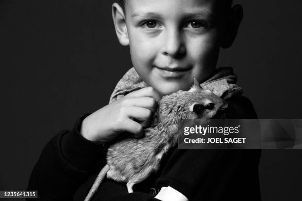 Axel poses with Curacao a gerbil on October 1, 2021 ahead of the Animal Expo Fair which takes place on October 2 and 3 at the Parc Floral, in Paris.