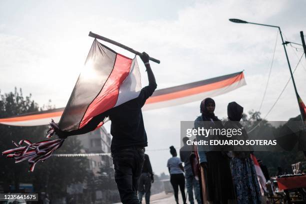 Street vendor sells flags and merchandises depicting the Oromo regional colours in the streets of the city of Bishoftu, on October 2 thanksgiving...