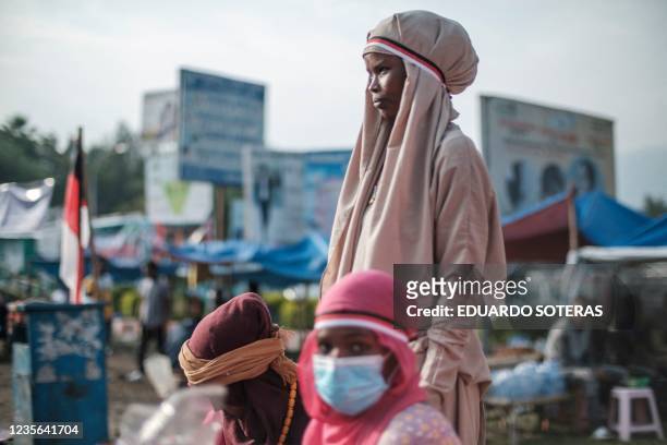 Street vendors sell flags and merchandises depicting the Oromo regional colours in the streets of the city of Bishoftu, on October 2 thanksgiving...