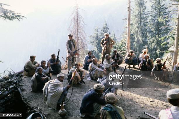 Afghan anti-Soviet resistance fighters armed with Egyptian copy of Soviet Kalashnikov assault rifle train on August 15, 1980 in a camp in Parachinar,...