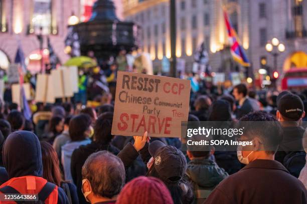 Demonstrator holds a placard during the protest against Chinese Communist Party repression on Hong Kong, Tibet, and Xinjiang on China's National Day...