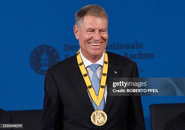 Romanian President Klaus Iohannis smiles after having been awarded with the 2020 International Charlemagne Prize in Aachen, western Germany on...