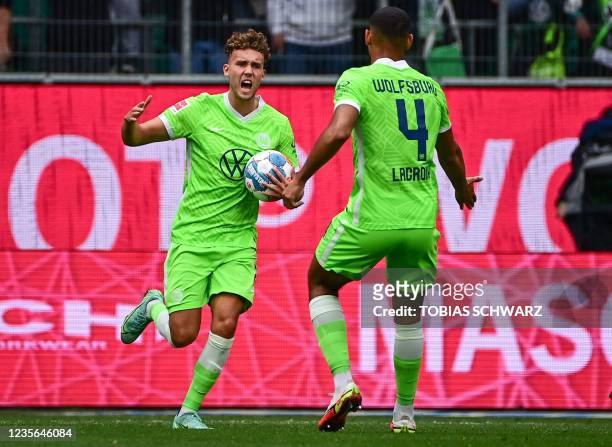 Wolfsburg's German forward Luca Waldschmidt celebrates scoring the 1-2 with his teammate Wolfsburg's French defender Maxence Lacroix during the...