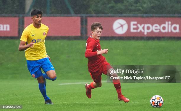 Tommy Pilling of Liverpool and Sonny Singh of Sunderland in action at AXA Training Centre on October 2, 2021 in Kirkby, England.