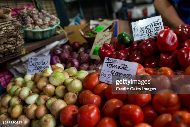 Detail of vegetables' prices are written in both old and new Bolivar currencies at a public market on October 2, 2021 in Caracas, Venezuela....