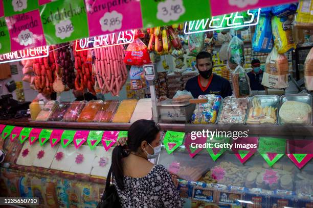 Customer shops at a butcher's shop where prices are written in US currency at La Candelaria neighborhood on October 2, 2021 in Caracas, Venezuela....