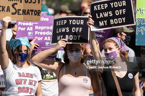 Women Rights Rally Button Women rights activists hold up signs as they gather at Freedom Plaza ...