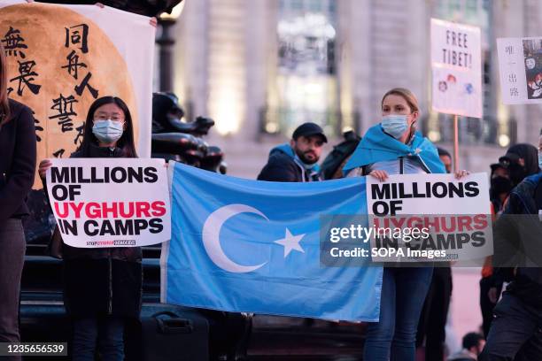 Colombe Cahen-Salvador , human rights activist, was seen holding the East Turkestan Flag, along with the sign that says 'Millions of Uyghurs in...
