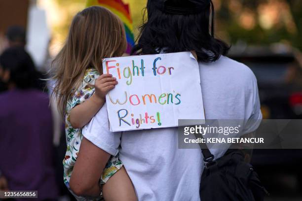 Girl holds a placard as protesters take part in the Women's March and Rally for Abortion Justice in New York, on October 2, 2021. - The abortion...