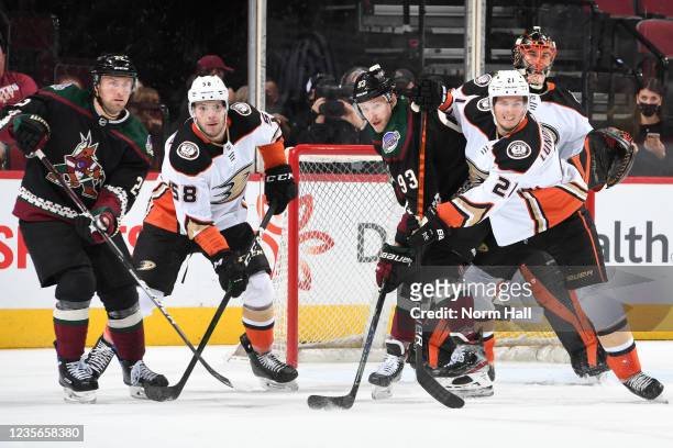 Brogan Rafferty and Isac Lundestrom of the Anaheim Ducks defend against Johan Larsson and Dmitrij Jaskin of the Arizona Coyotes during the first...