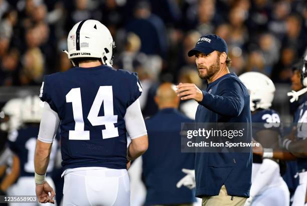 Penn State offensive coordinator Mike Yurcich talks with quarterback Sean Clifford before the Indiana Hoosiers versus Penn State Nittany Lions game...