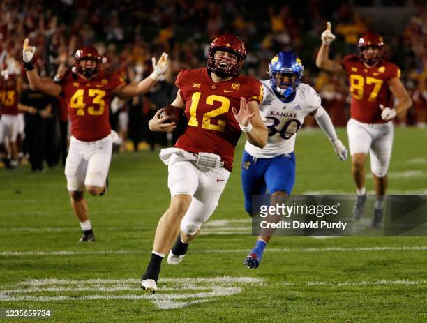 Quarterback Hunter Dekkers of the Iowa State Cyclones drives the ball to the end zone for a touchdown as linebacker Rich Miller of the Kansas...
