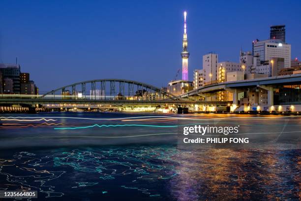 This long exposure picture shows the Tokyo Skytree lit during the evening in Tokyo on October 3, 2021.