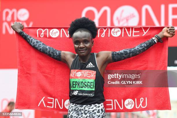 Kenya's Joyciline Jepkosgei poses for a photograph after winning the women's race of the 2021 London Marathon in central London on October 3, 2021. /...