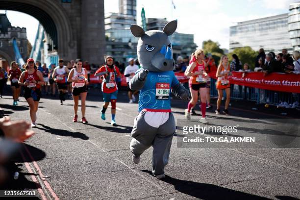 Runner in fancy dress runs over Tower Bridge as they compete in the 2021 London Marathon in central London on October 3, 2021. - - Restricted to...