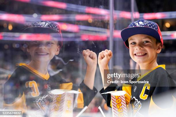 Young fans cheers from the front row during the second period in the preseason NHL game between the Pittsburgh Penguins and the Detroit Red Wings on...