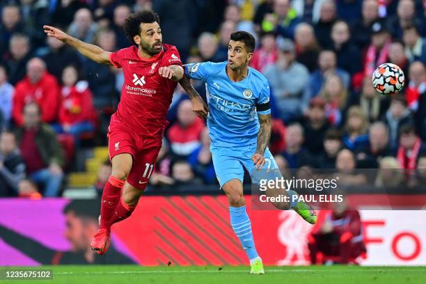 Liverpool's Egyptian midfielder Mohamed Salah challenges Manchester City's Spanish midfielder Rodrigo during the English Premier League football...