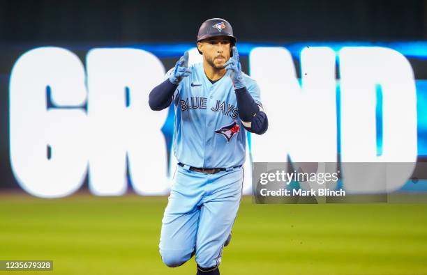 George Springer of the Toronto Blue Jays celebrates his grand slam home run against the Baltimore Orioles in the third inning during their MLB game...