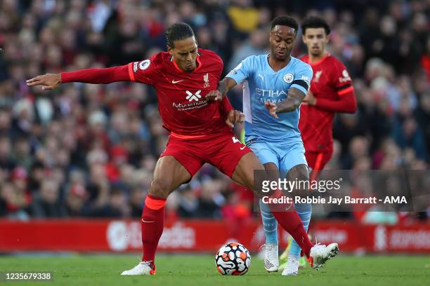Virgil van Dijk of Liverpool tackles Raheem Sterling of Manchester City during the Premier League match between Liverpool and Manchester City at...