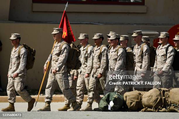 Marines from the 2nd Battalion, 1st Marines, who had been deployed to Afghanistan, arrive in formation for their homecoming at US Marine Corps Base...
