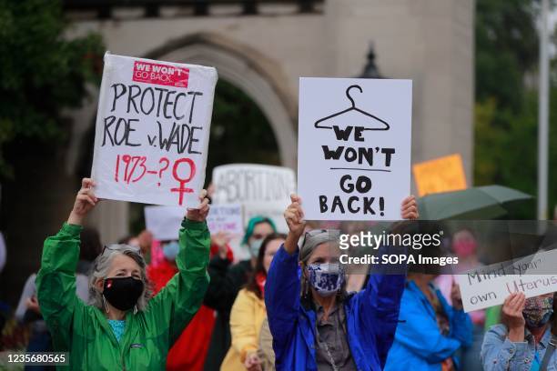Demonstrators gather with placards expressing their opinion at the Sample Gates at Indiana University to rally in support of womens reproductive...