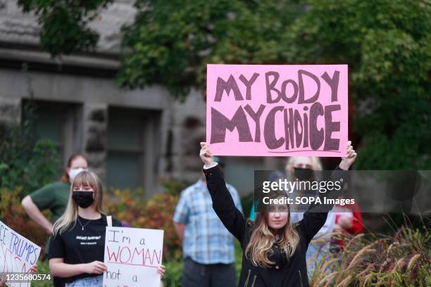 Demonstrator holds a placard saying "My Body My Choice" as they gather at the Sample Gates at Indiana University to rally in support of womens...