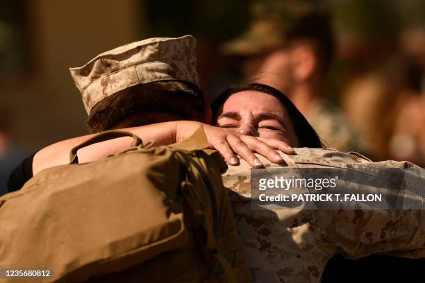 Marine is hugged as family and friends are reunited with Marines from the 2nd Battalion, 1st Marines, who had been deployed to Afghanistan, during...
