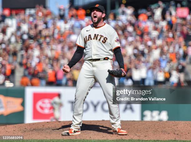 Dominic Leone of the San Francisco Giants celebrates as the Giants clinch NL West after their game against the San Diego Padres at Oracle Park on...