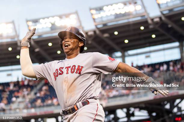 Rafael Devers of the Boston Red Sox reacts after hitting a go-ahead two run home run during the ninth inning of a game against the Washington...