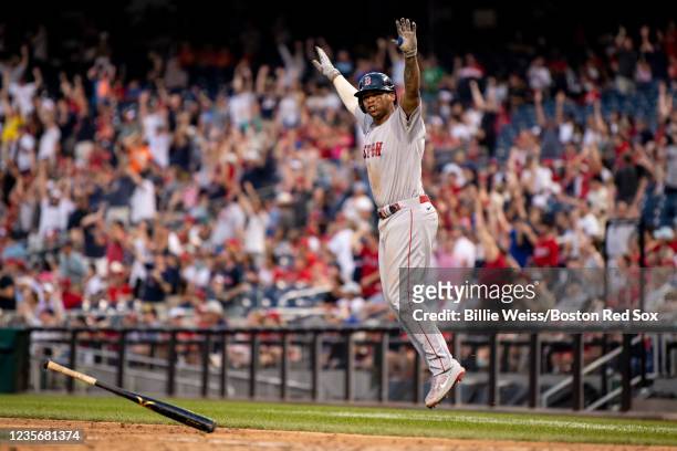 Rafael Devers of the Boston Red Sox reacts after hitting a go-ahead two run home run during the ninth inning of a game against the Washington...