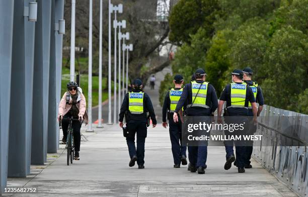 Police patrol the quiet streets of Melbourne on October 4, 2021.