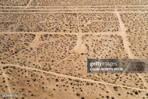 In this aerial picture taken on September 25, 2021 a vast network of roads cut in the Mojave Desert, intended for a massive suburban paradise that...