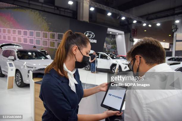 An information hostess of the Hyundai brand attends to a visitor at the Automobile Barcelona. The Automobile Barcelona is being held after two years...