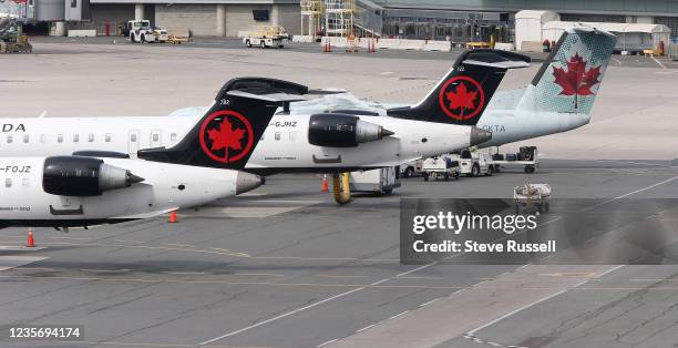 Toronto, ON- September 25 - Air Canada planes sit on the tarmac at the airport. Passengers arriving on international flights go through COVID-19...
