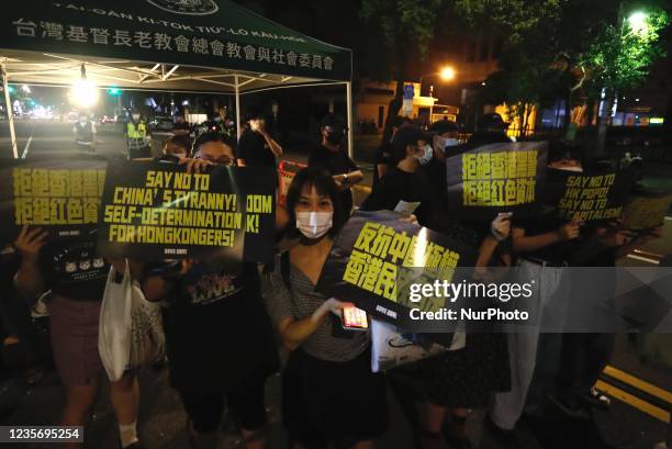 Protesters hold signs reading anti Chinese totalitarianism, say no to Chinas tyranny and Hong Kong Independence flags, during an anti china and...