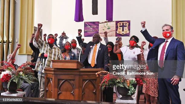 Civil rights attorney Ben Crump, center, along with lawyer Christopher Seeger, right, and the family of Henrietta Lacks raise their fists as they...