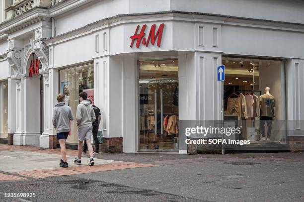 Pedestrians walk by H&M Fashion Store on Royal Avenue.